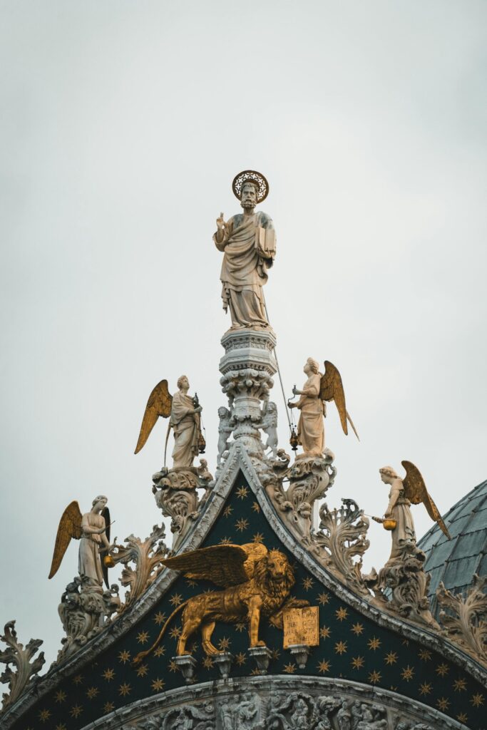Detailed view of Saint Mark's Basilica facade with ornate sculptures in Venice, Italy.